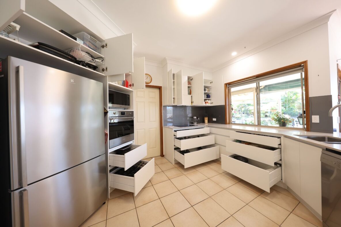 modern kitchen renovation with cabinetry open and stainless steel appliances